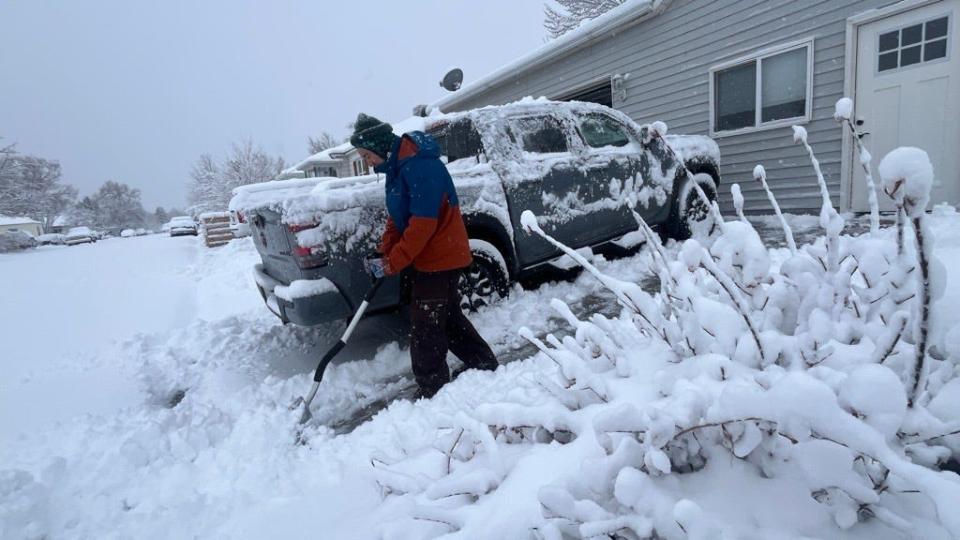 Meikon Gasuad shovels his driveway in Reno, Nevada on Saturday, March 2, 2024.