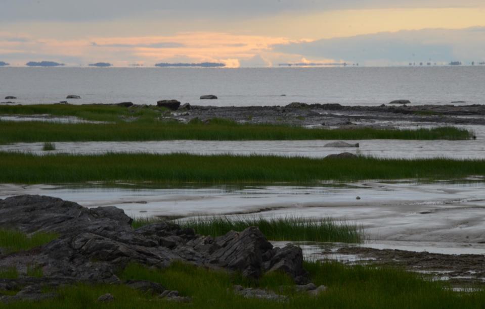 This photo taken Aug. 14, 2013, looks out over the broad St. Lawrence River at dusk from the Route Verte bicycle network outside Montmagny, Quebec. Route Verte offers more than 3,000 miles of bicycle-friendly roads and off-roads trails in Quebec and the ride along the St. Lawrence is one of the best sections for natural beauty. (AP Photo/Calvin Woodward)