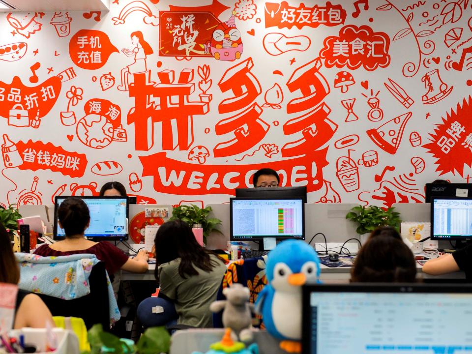 FILE PHOTO: People are seen at their desks at the headquarters of Chinese online group discounter Pinduoduo in Shanghai, China July 25, 2018. REUTERS/Stringer/File Photo  