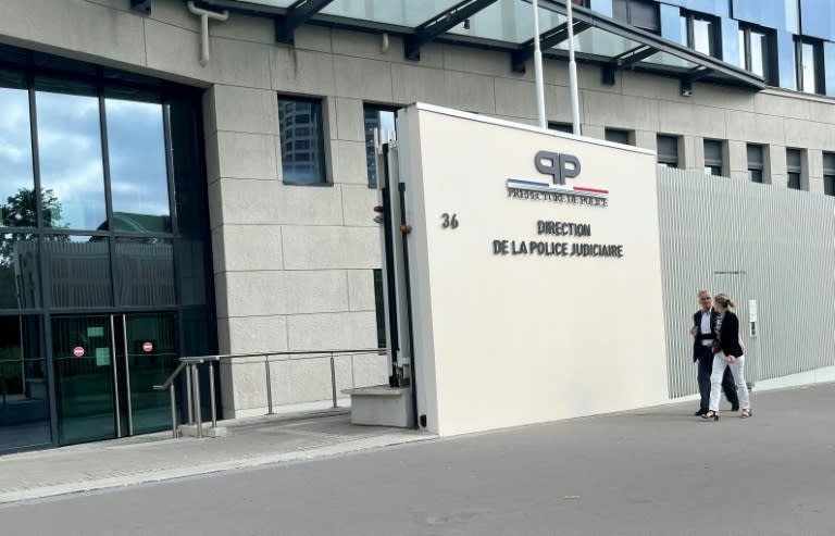 Jacquot (left) arrives at a Paris police station for questioning (Guillaume DAUDIN)