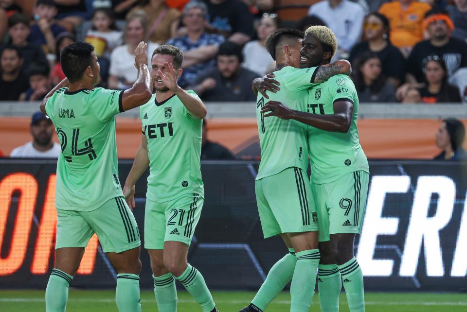 Austin FC forward Gyasi Zardes celebrates with teammates after scoring a goal during the first half of Saturday night's 2-1 loss to Houston Dynamo FC. It was the 100th goal of Zardes' career.