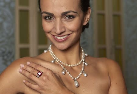 A model wearing the "Graff Ruby" a 8.32 carats red hue "pigeon blood" Burmese stone, and a natural pearl and diamond necklace that belonged to Josephine de Beauharnais, Queen of Norway and Sweden (1807-1876) during an auction preview Sotheby's auction house in Geneva, in this November 5, 2014 file photo. REUTERS/Denis Balibouse/Files