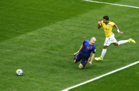 Arjen Robben of the Netherlands falls after having his shirt pulled by Brazil's Thiago Silva in the penalty box during their 2014 World Cup third-place playoff at the Brasilia national stadium in Brasilia July 12, 2014. REUTERS/Ruben Sprich