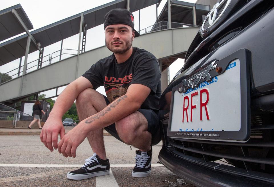 Anthony Killion, of Framingham and his vanity license plate, RFR,  an acronym for "Running From Roots," pictured at the Framingham train station, July 21, 2023. 