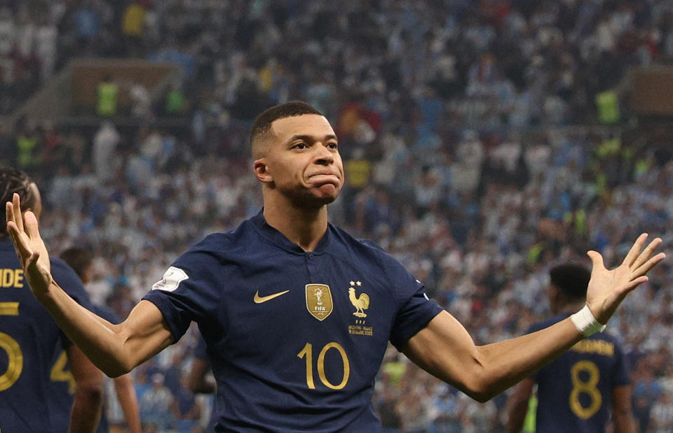 France's forward #10 Kylian Mbappe (R) celebrates scoring his team's second goal during the Qatar 2022 World Cup final football match between Argentina and France at Lusail Stadium in Lusail, north of Doha on December 18, 2022. (Photo by Adrian DENNIS / AFP) (Photo by ADRIAN DENNIS/AFP via Getty Images)