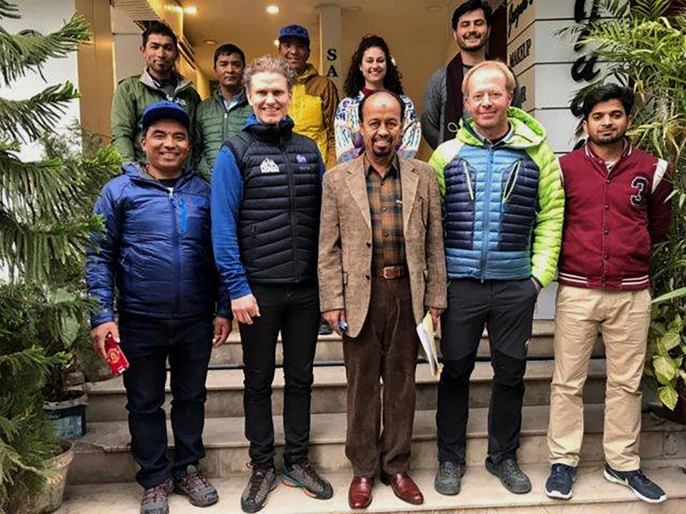 In this Jan. 8, 2020, photo provided by Alpine Club of Pakistan, Iceland's mountaineer John Snorri, second left in front row, and his team members pose for photograph with Karrar Haider, a top official of Alpine Club of Pakistan, center in front row, after a meeting, in Islamabad, Pakistan. An aerial search mission is on to find three experienced climbers, Ali Sadpara and his two companions, John Snorri and Juan Pablo Mohr, who lost contact with the base camp during their ascend on world's second top peak in northern Pakistan, official said Sunday, Feb. 7, 2021. (Alpine Club of Pakistan via AP)