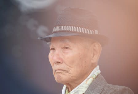 Lee Choon-shik, a victim of wartime forced labor during the Japanese colonial period, reacts as he attends during an anti-Japan protest on Liberation Day in Seoul