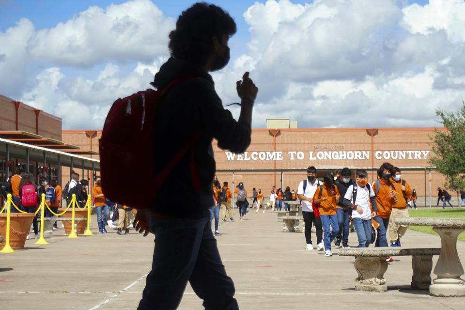 FILE - Stillman Middle School students walk through their campus courtyard to class during their first day back to school on Aug. 17, 2021, in Brownsville, Texas. Test scores in history and civics have declined slightly for eighth-grade students in the U.S., according to results that show an increasing number of children lack a basic understanding in either subject, according to the the National Assessment of Educational Progress Wednesday, May 3, 2023. (Miguel Roberts/The Brownsville Herald via AP, File)