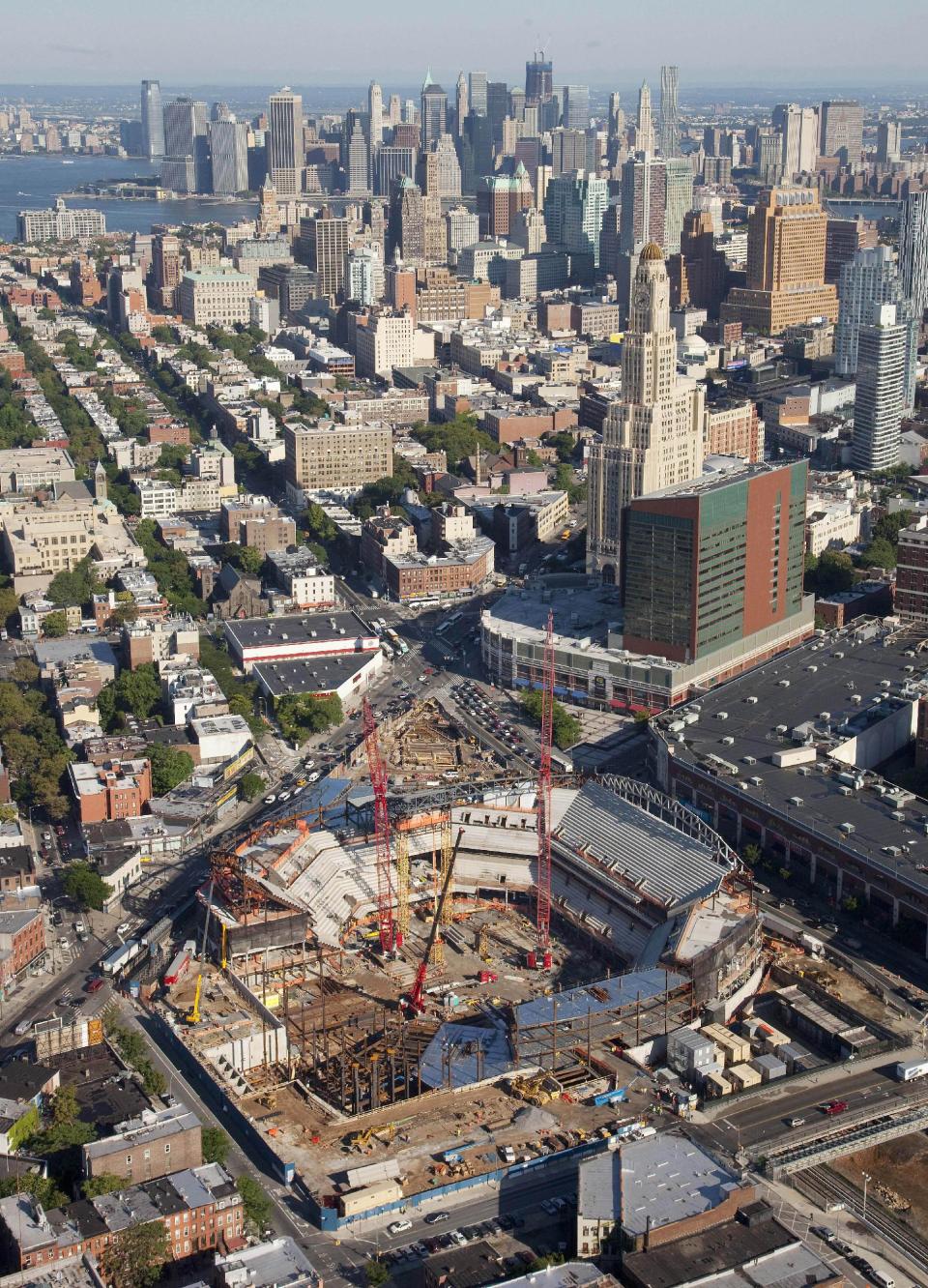 FILE - In this aerieal file photo of July 27, 2011, construction of the Barclays Center is underway for the new home of the Nets basketball team in the Brooklyn borough of New York. On Friday, Sept. 21, 2012, after decades without a professional sports team, New York City’s ascendant borough is hitting the major leagues again - but this time it’s basketball, not baseball, that’s taking over. (AP Photo/Mark Lennihan, File)