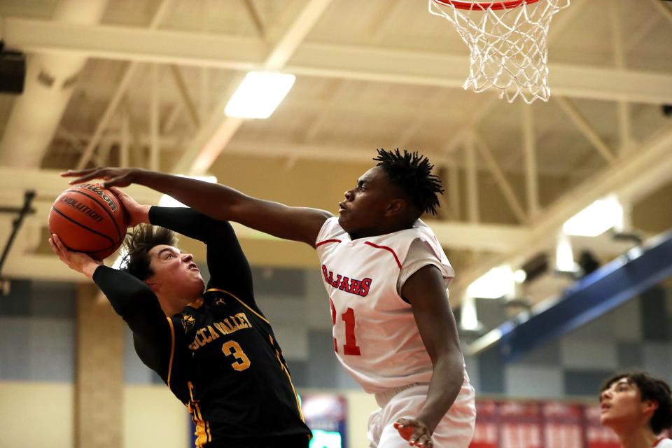 Yucca Valley's Cooper Hopton (3) is fouled by Indio's Jamerson McClendon (21) in Indio, Calif., on Monday, Jan. 24, 2022. Indio won. 