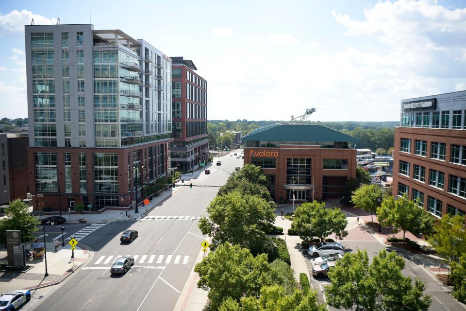 Van Alen luxury apartments, left, overlook Durham Bulls Athletic Park in downtown Durham, North Carolina. Apartments in the area have contributed to a higher number of young professionals attending Bulls games, and Tennessee Smokies owner Randy Boyd anticipates this demographic will increase upon the team's move to a downtown Knoxville stadium.