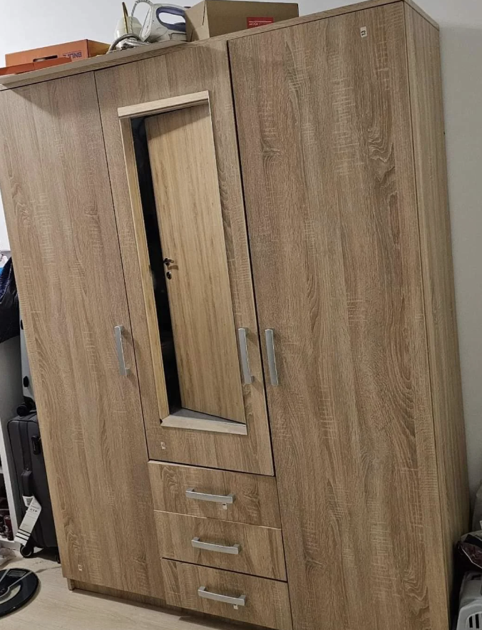 Wooden cabinet with mirror door, two doors on each side and four drawers under the mirror in a tidy, organized space