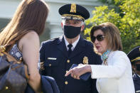 House Speaker Nancy Pelosi of Calif., talks with new U.S. Capitol Police chief Thomas Manger before President Joe Biden signs a bill in the Rose Garden of the White House, in Washington, Thursday, Aug. 5, 2021, that awards Congressional gold medals to law enforcement officers that protected members of Congress at the Capitol during the Jan. 6 riots. (AP Photo/Susan Walsh)