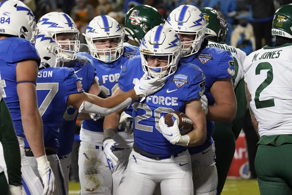 Air Force running back Brad Roberts (20) is congratulated by teammates after scoring a touchdown against Baylor during the first half of the Armed Forces Bowl NCAA college football game in Fort Worth, Texas, Thursday, Dec. 22, 2022. (AP Photo/LM Otero)