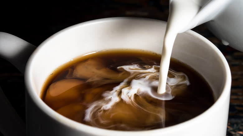 Creamer poured into coffee