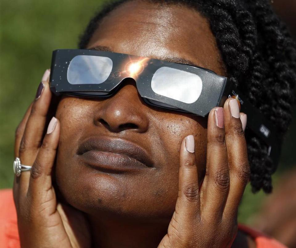 Glenda Guy of Lexington watched the eclipse at the Arboretum State Botanical Garden of Kentucky. Guy and her family were among more than 1,000 people gathered in the Arboretum to watch the eclipse.