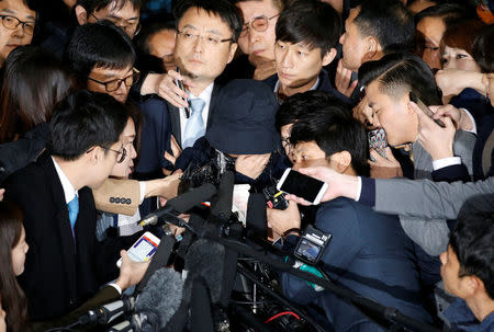 Choi Soon-sil (C), who is involved a political scandal, is surrounded by media upon her arrival at a prosecutor's office in Seoul, South Korea, October 31, 2016. REUTERS/Kim Hong-Ji