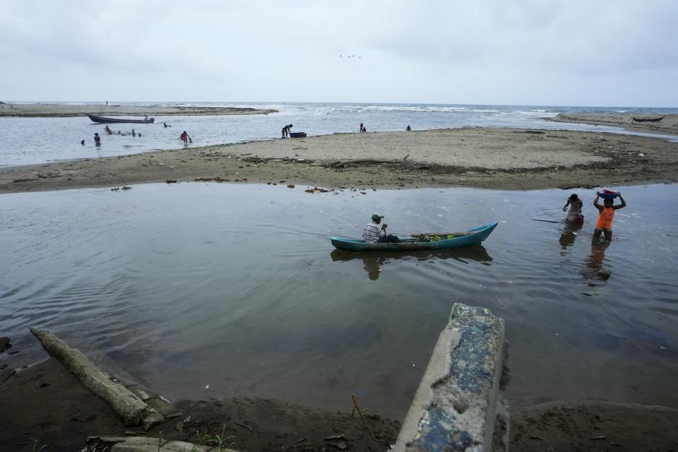 Guna Indigenous use water of the Armila River to do laundry in Armila, Panama, Friday, May 19, 2023. (AP Photo/Arnulfo Franco)