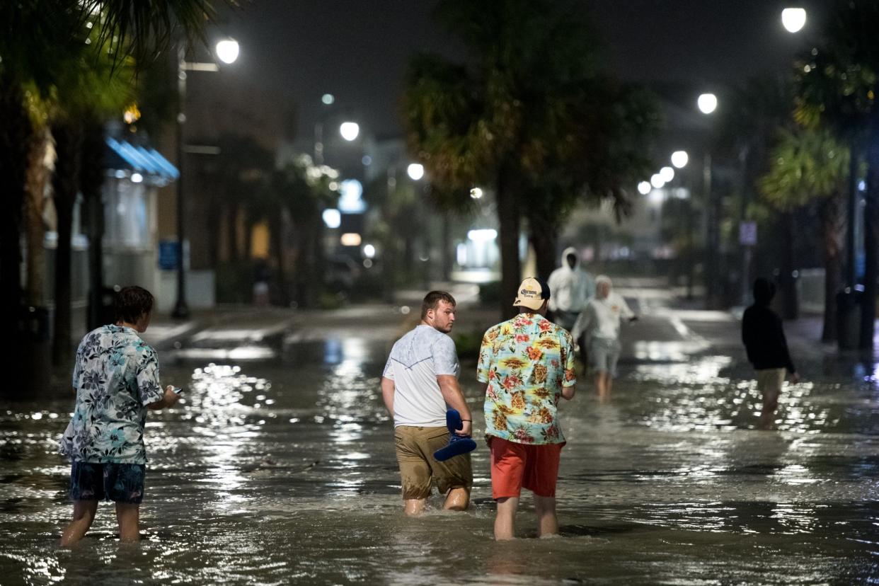 People walk through floodwaters on Ocean Blvd in Myrtle Beach, South Carolina on Monday: Getty Images