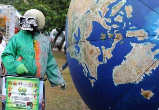 An activist takes part in a protest during the last day of the People's Summit in Rio de Janeiro during the UN Rio+20 Conference on Sustainable Development. The biggest UN summit on sustainable development in a decade approved a strategy on Friday to haul more than a billion people out poverty and cure the sickness of the biosphere