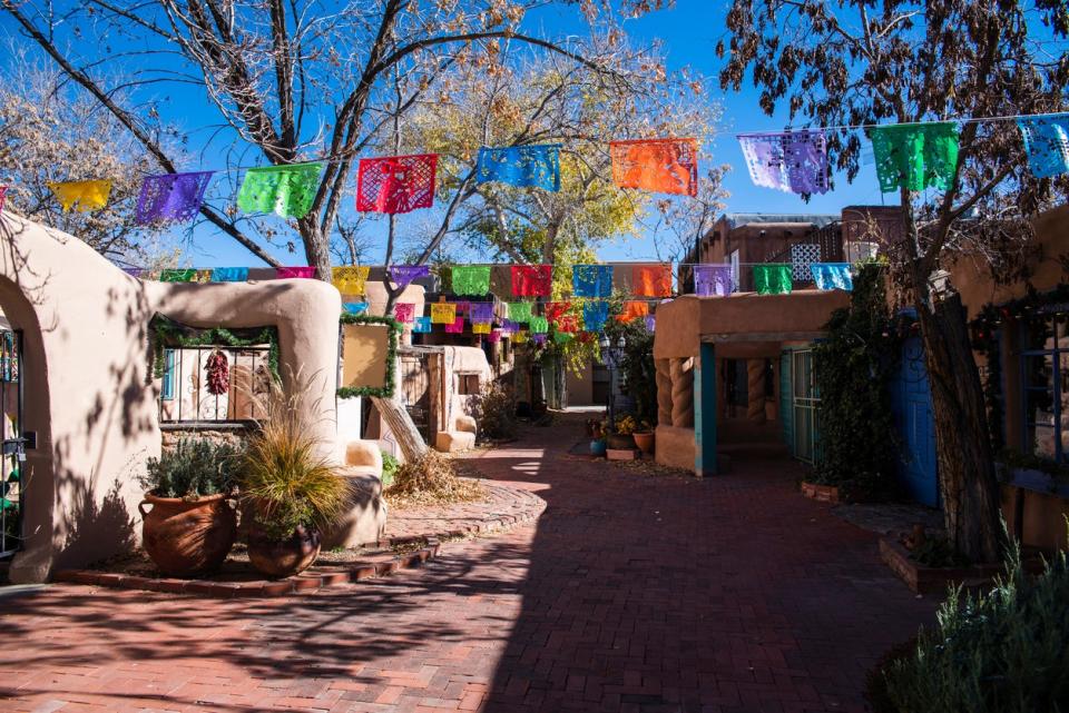 Colorful flags hanging in the historic district of Albuquerque, New Mexico, USA.
