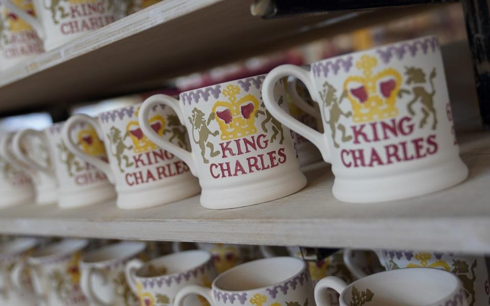 King Charles III themed mugs on display during the production of hand-decorated pieces from the forthcoming Coronation collection, at the Emma Bridgewater Pottery Factory in Stoke on Trent - Jacob King