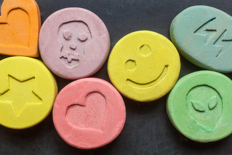 Ecstasy tablets on black background