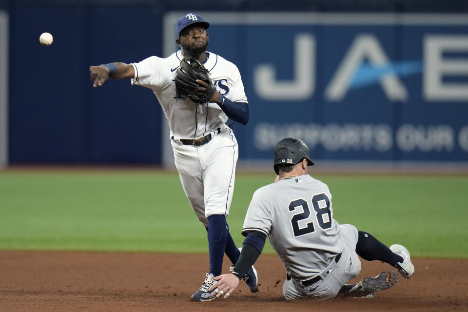 Tampa Bay Rays second baseman Vidal Brujan forces New York Yankees' Josh Donaldson (28) at second base and relays the throw to first in time to turn a double play on Giancarlo Stanton during the eighth inning of a baseball game Tuesday, June 21, 2022, in St. Petersburg, Fla. (AP Photo/Chris O'Meara)