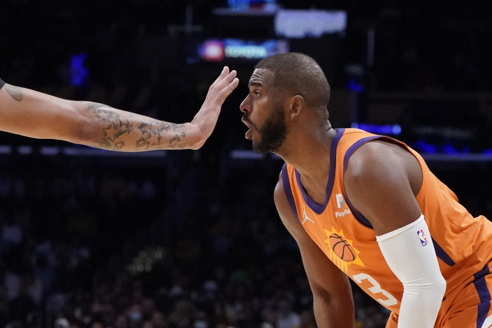 Los Angeles Lakers forward Anthony Davis, left, places his hand in front of the face of Phoenix Suns guard Chris Paul (3) during the first half of an NBA basketball game Friday, Oct. 22, 2021, in Los Angeles. (AP Photo/Marcio Jose Sanchez)