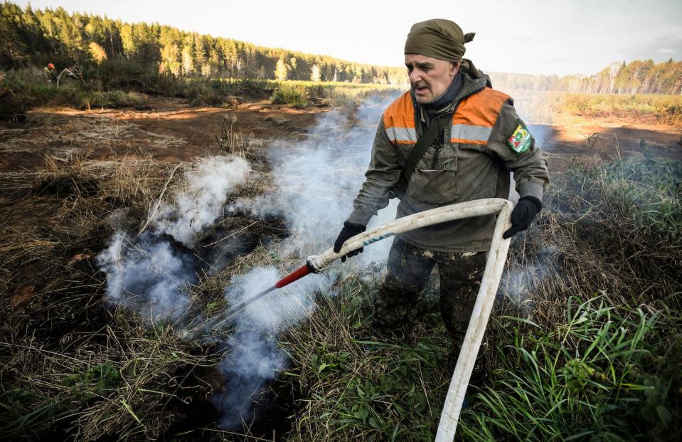 A volunteer fights ‘zombie’ peat fires in Siberia in 2020, a year when an estimated 100,000 square miles of forest, grassland and peatland burned, according to an International Association of Wildland Fire analysis. <a href="https://www.gettyimages.com/detail/news-photo/local-activist-extinguishes-a-peat-fire-in-a-suzunsky-news-photo/1228677175" rel="nofollow noopener" target="_blank" data-ylk="slk:Alexander Nemenov / AFP via Getty Images;elm:context_link;itc:0;sec:content-canvas" class="link ">Alexander Nemenov / AFP via Getty Images</a>