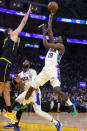 Philadelphia 76ers forward Shake Milton (18) shoots over Golden State Warriors forward Nemanja Bjelica during the first quarter of an NBA basketball game Wednesday, Nov. 24, 2021, in San Francisco. (AP Photo/D. Ross Cameron)