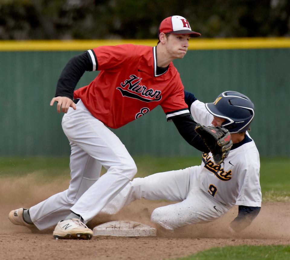 Adams Goins of Airport steals second base as New Boston Huron shortstop Cole Grunwald waits for the ball .