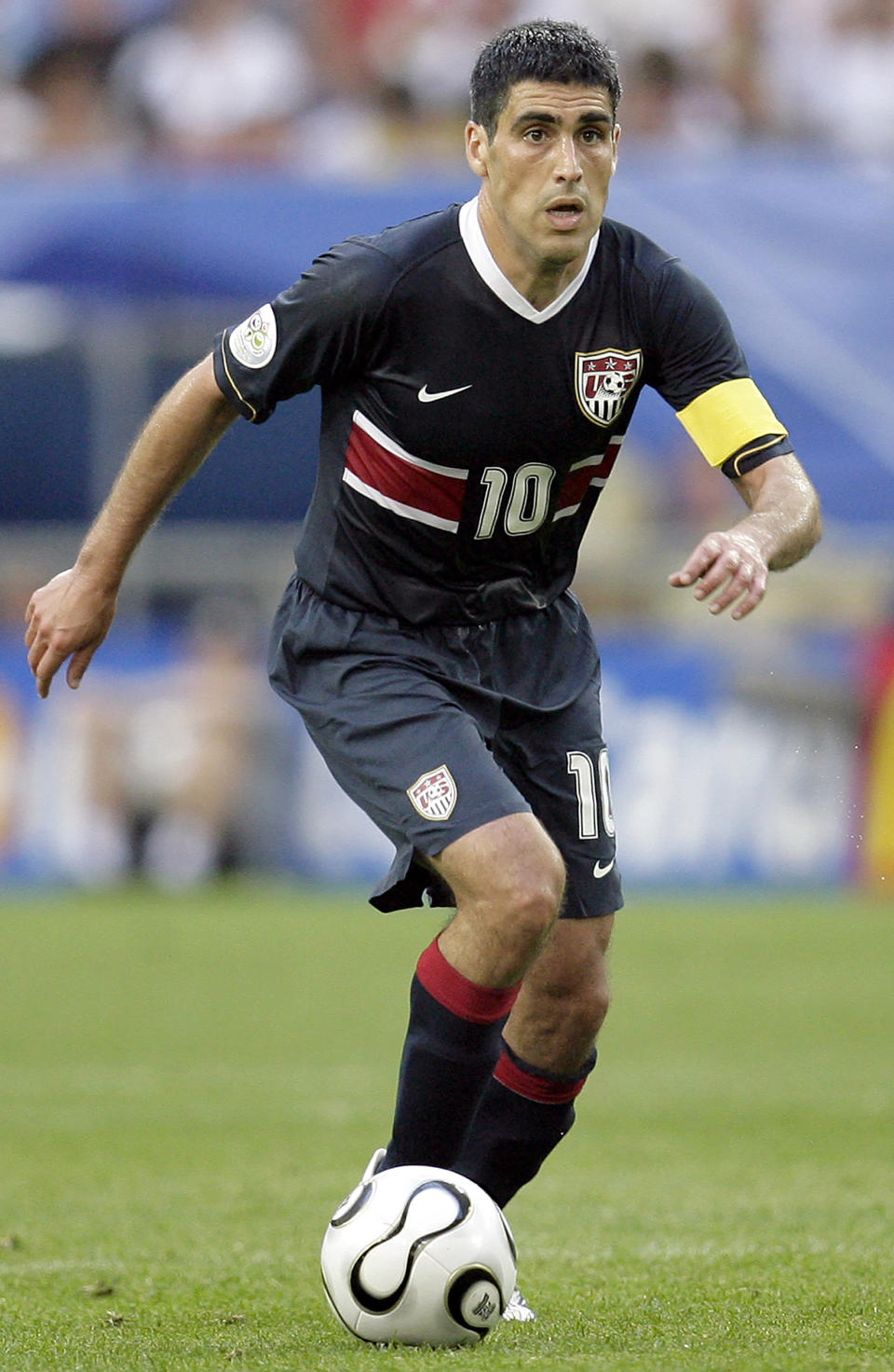 FILE - United States' Claudio Reyna plays the ball during the World Cup, Group E soccer match between the United States and the Czech Republic, at the Gelsenkirchen stadium, Germany, Monday, June 12, 2006. Gio Reyna, the son of former U.S. captain Claudio Reyna and women's national team midfielder Danielle Egan, was compared with Maradona in the '86 World Cup by U.S. coach Gregg Berhalter after a USA vs Mexico qualifying match in Mexico City on Thursday, March 24, 2022. (AP Photo/Michael Sohn, File)