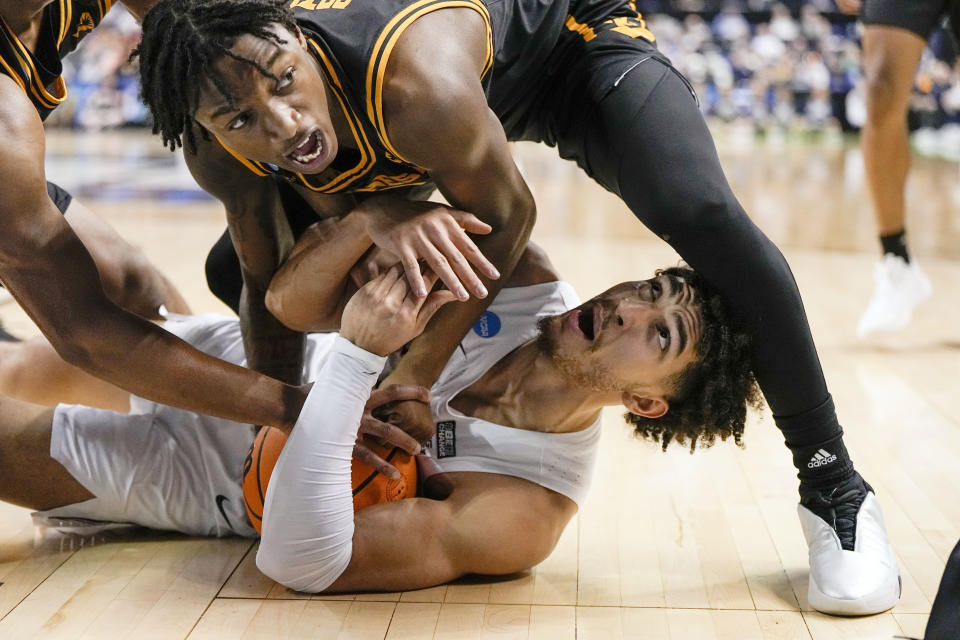 Kennesaw State guard Simeon Cottle, top, vies for the ball with Xavier guard Colby Jones during the first half of a first-round college basketball game in the NCAA Tournament on Friday, March 17, 2023, in Greensboro, N.C. (AP Photo/Chris Carlson)