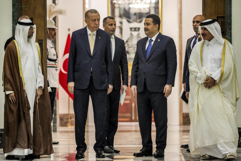 Iraq's Prime Minister Mohammed Shia al-Sudani, second right, receives Turkey's President Recep Tayyip Erdogan, second left, Qatar's Minister of Transport Jassim bin Saif bin Ahmed al-Sulaiti, right, and UAE's Minister of Energy Suhail Mohamed al-Mazrouei, left, ahead of their meeting in Baghdad, Iraq, Monday April 22, 2024. (Ahmad Al-Rubaye/Pool via AP)