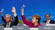 Delegates votes on the German coalition deal after new cabinet picks during a Christian Democratic Union (CDU) party congress in Berlin, Germany, February 26, 2018. REUTERS/Fabrizio Bensch