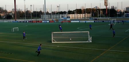 Boys from the RCD Espanyol soccer academy practice during a training session at Dani Jarque training camp in Sant Adria de Besos, near Barcelona, Spain February 20, 2017. REUTERS/ Albert Gea/Files