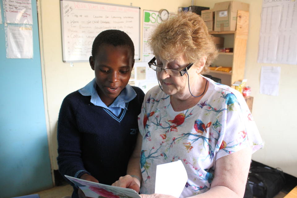 Mary Coyne works with a student in Malawi. (Wells for Zoë/Flickr)