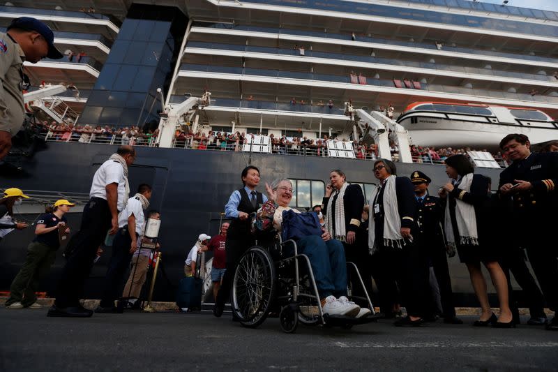 Passengers of MS Westerdam, a cruise ship that spent two weeks at sea after being turned away by five countries over fears that someone aboard might have the coronavirus, get off as it docks in Sihanoukville,