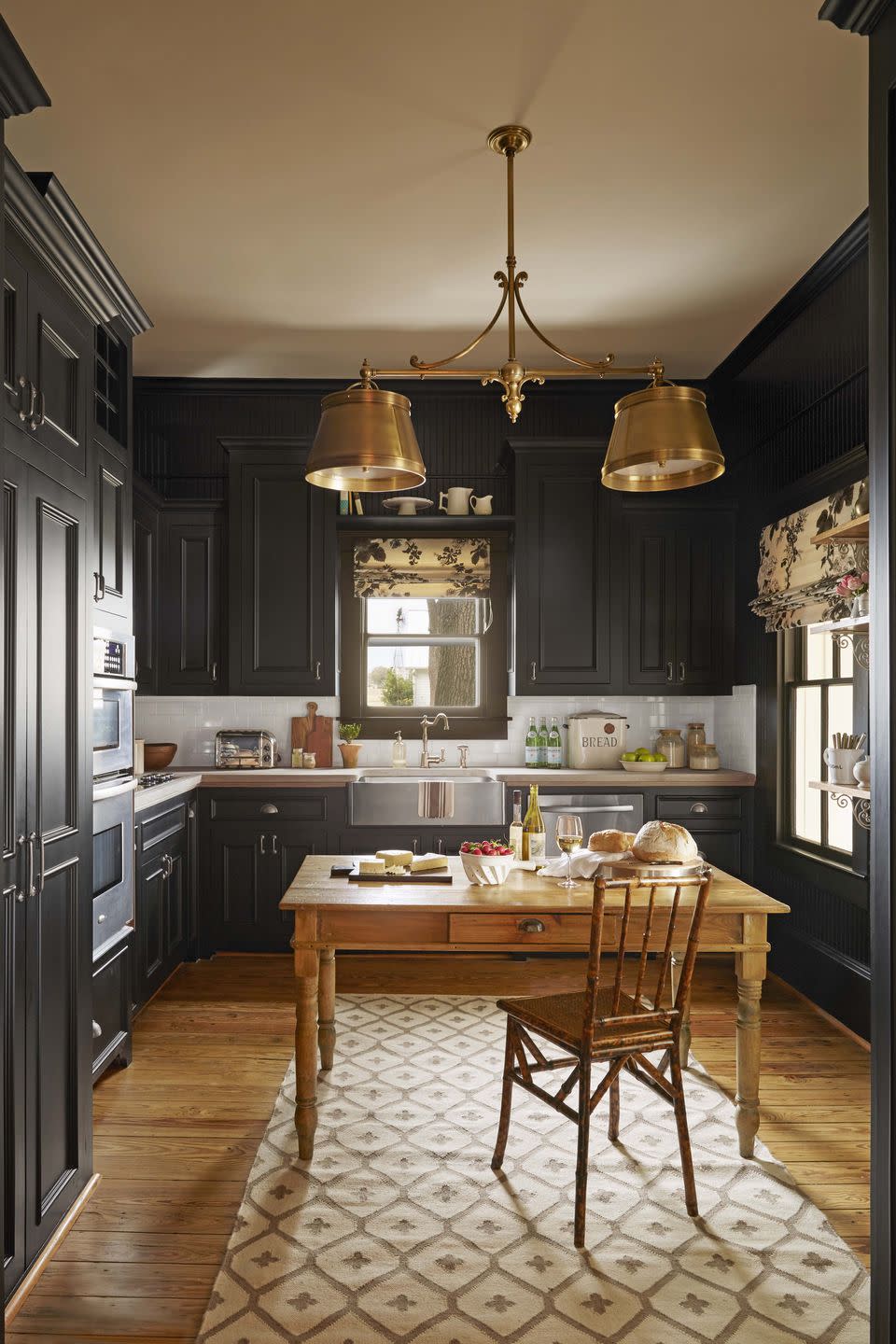 kitchen with black floor to ceiling cabinetry and black wall