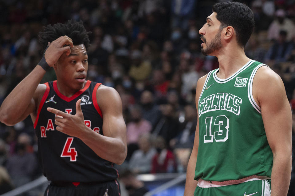 Boston Celtics' Enes Kanter (13) stands next to Toronto Raptors' Scottie Barnes during a free throw in the first half of an NBA basketball game Sunday, Nov. 28, 2021 in Toronto. (Chris Young/The Canadian Press via AP)