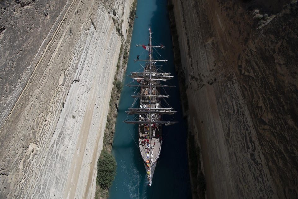 Belem, the three-masted sailing ship carrying the Olympic flame to France, is being towed through the Corinth canal in Corinth, Greece, Sunday, April 28, 2024. (AP Photo/Michael Varaklas)
