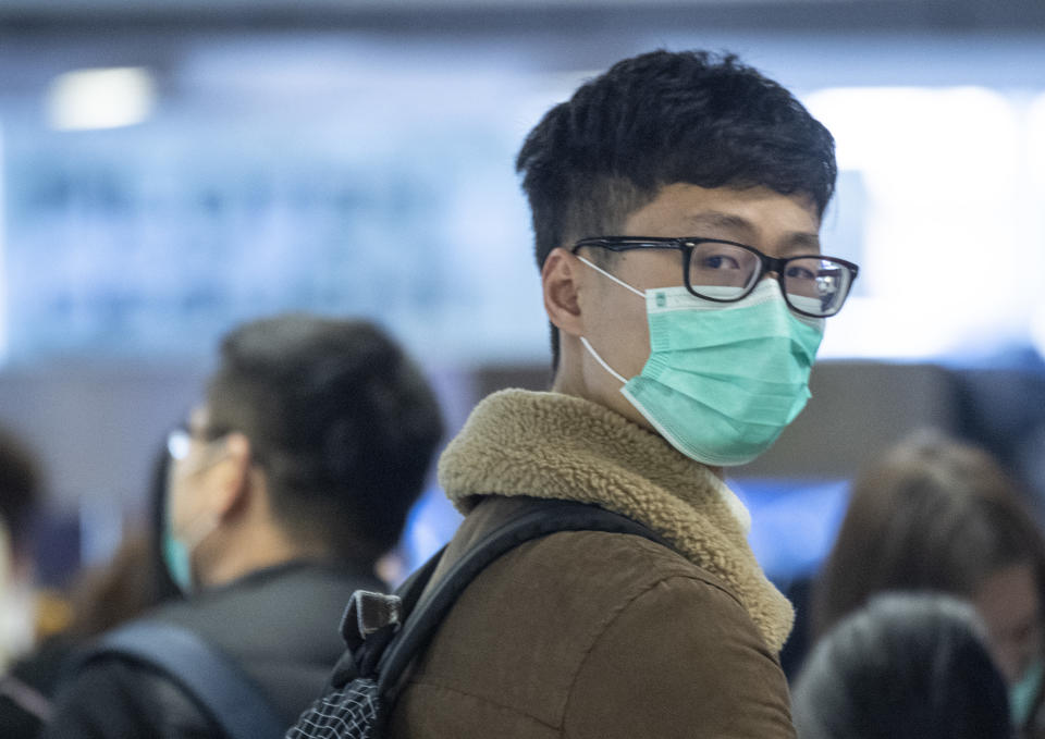 30 January 2020, Hessen, Frankfurt/Main: Face masks are worn by passengers waiting at Frankfurt Airport for the check-in of the Chinese airline Air China. For fear of the new coronavirus, many passengers wear masks. Photo: Boris Roessler/dpa (Photo by Boris Roessler/picture alliance via Getty Images)