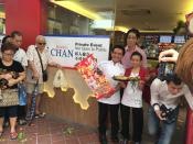 <p>Chan Hon Ming, his wife and Hersing Culinary chairman Harry Chua outside Hawker Chan. </p>
