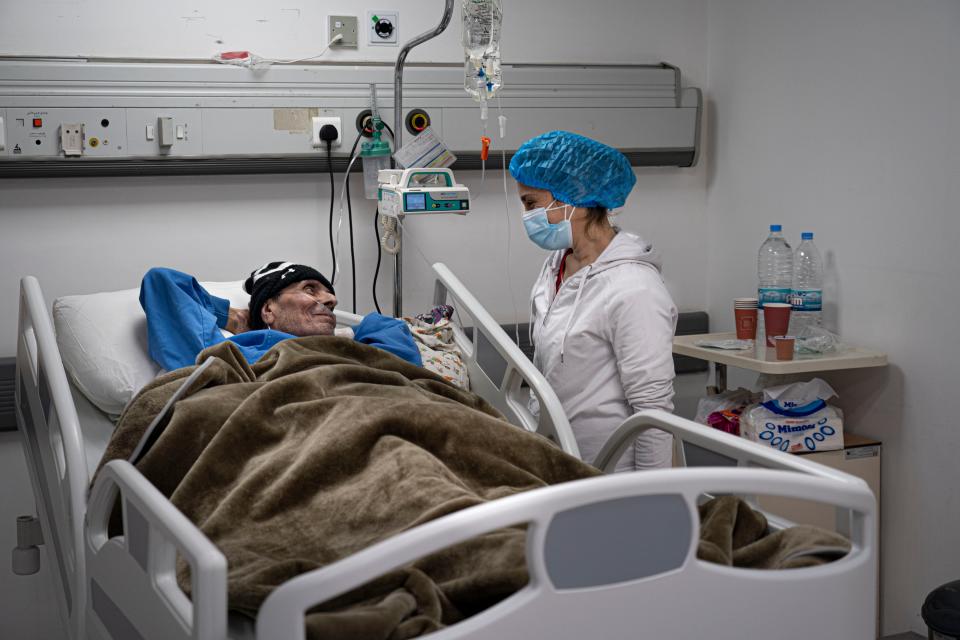 A nurse tends to her sick father in a coronavirus ward at the Rafic Hariri University HospitalBel Trew