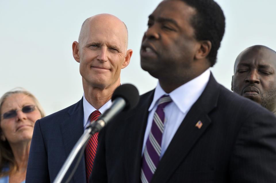 Then-Gov. Rick Scott listens to Jacksonville Mayor Alvin Brown at JaxPort in 2013 as the two fought for federal approval to deepen the port.