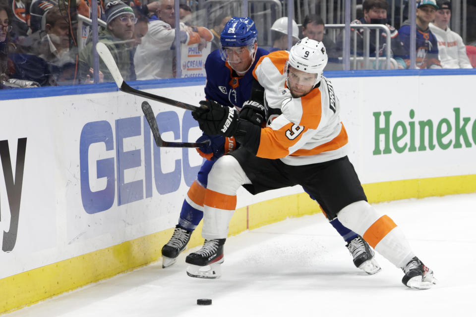 New York Islanders center Brock Nelson (29) and Philadelphia Flyers defenseman Ivan Provorov (9) fight for the puck during the second period of an NHL hockey game, Tuesday, Jan. 25, 2022, in Elmont, N.Y. (AP Photo/Corey Sipkin).