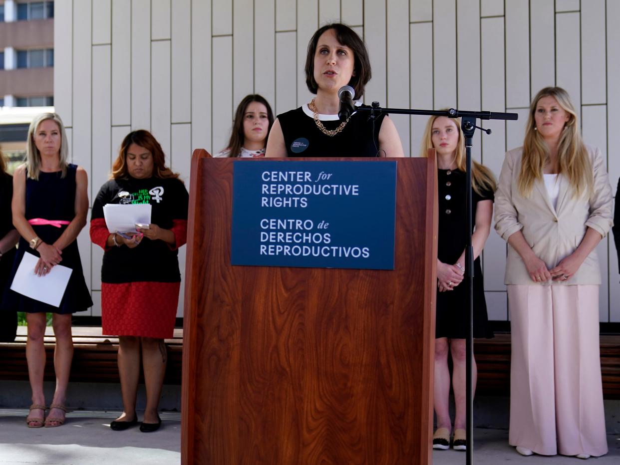 Attorney Molly Duane, center, stands with several of the plaintiffs in her case as she speaks to the media outside the Travis County Courthouse, Wednesday, July 19, 2023, in Austin, Texas.