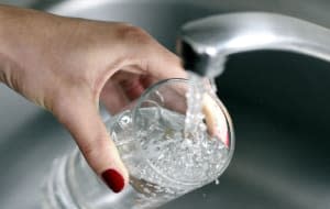 Woman fills glass of water