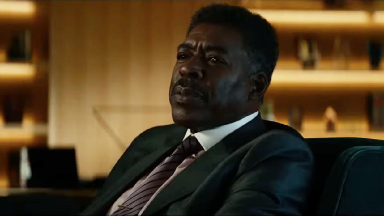  Ernie Hudson sits at his desk while telling a story in Ghostbusters: Afterlife. 